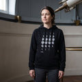 woman wearing a hoodie with Moon Phases design print and Royal Museums Greenwich logo