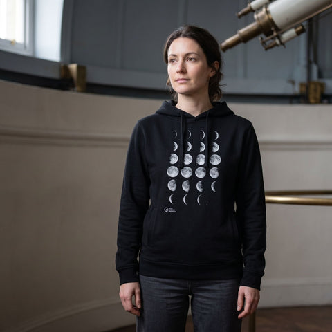 woman wearing a hoodie with Moon Phases design print and Royal Museums Greenwich logo