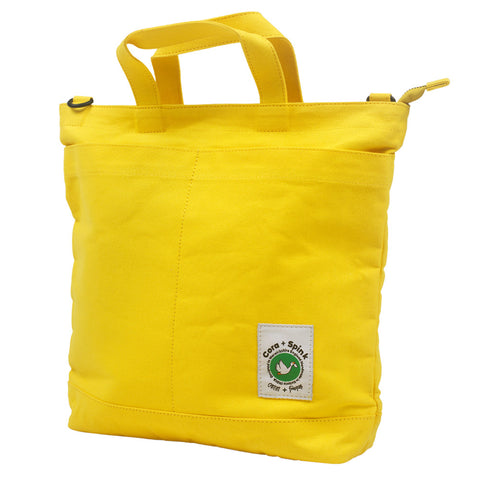 Yellow tote bag with a visible brand logo 