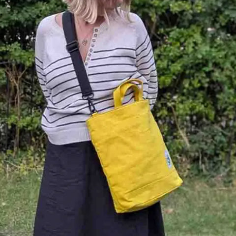 Yellow Cora + Spink Otter tote bag and model