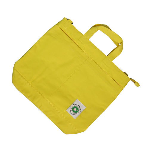 Yellow tote bag with a visible brand logo on a white background