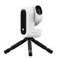 A white and black Seestar portable smart telescope on a small black tripod