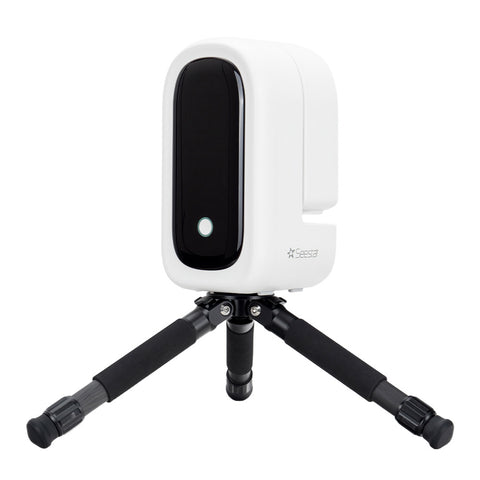 A white and black ZWO Seestar S50 Pro telescope on a black tripod