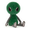 Green alien plush toy with metallic fabric legs on 