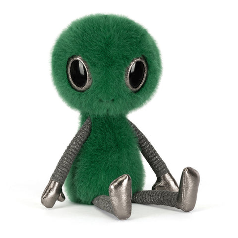Green alien plush toy with metallic fabric legs on 