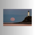 Photograph print of a lighthouse on a cliff with a pink moon in the sky