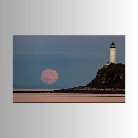 Photograph print of a lighthouse on a cliff with a pink moon in the sky