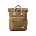 A tan Roka backpack with gray webbed top handles and small orange zipper pulls