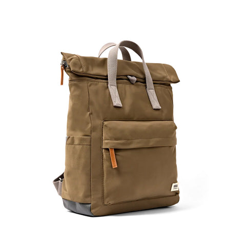 A roll-top canvas backpack in olive brown with light gray fabric handles and small orange zipper pulls