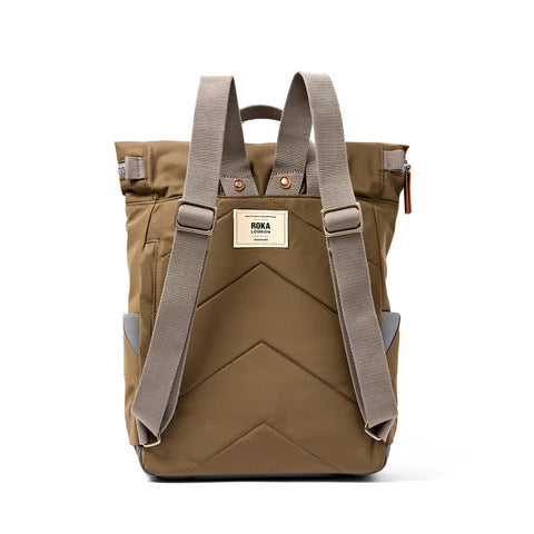 A brown backpack with gray webbed shoulder straps and a beige brand patch on the front