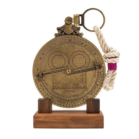 Brass and rope astrolabe on a wooden base.