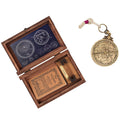 Brass and rope astrolabe on a wooden base with wooden display box.