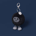 black hole plush bag charm on navy background