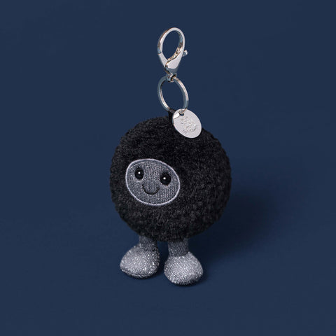 black hole plush bag charm on navy background