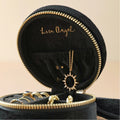 Black jewelry box with gold accents containing a necklace and rings, branded 'Lisa Angel'.