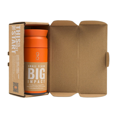 Orange flask in cardboard packaging. 