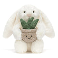 Cream plush bunny toy holding a plant in pot