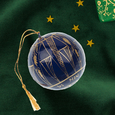 Decorative blue ornament with gold patterns and compass markings