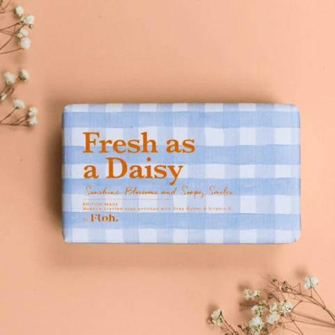 Bar of soap with 'Fresh as a Daisy' text on a checkered background