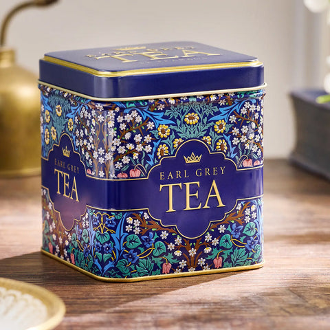 Decorative tea tin labelled 'Earl Grey Tea' on a wooden surface.