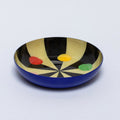 Black and white striped bowl featuring colourful circles and blue underside.