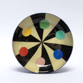 Black and white striped bowl featuring colourful circles.