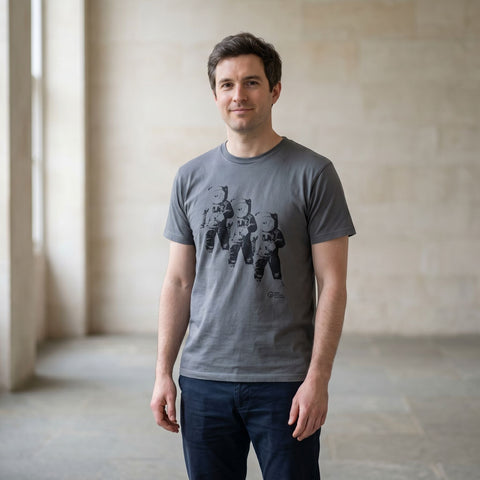 man wearing a grey tshirt with a print f three astronaouts on the front