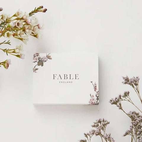 White and floral Fable packaging.