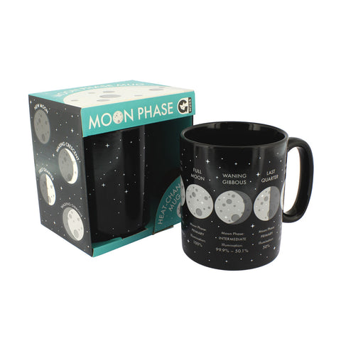 Black mug with small silver stars and moon phase design and information next to its box.