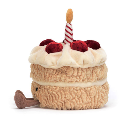 Plush toy birthday cake with a candle and strawberries on the top
