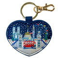 Heart-shaped keychain with London-themed design featuring Big Ben, a red bus, and Christmas trees on a blue background.