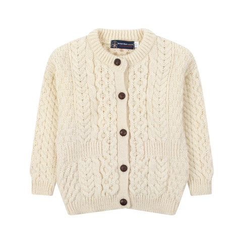 Cream knitted cardigan with brown buttons.