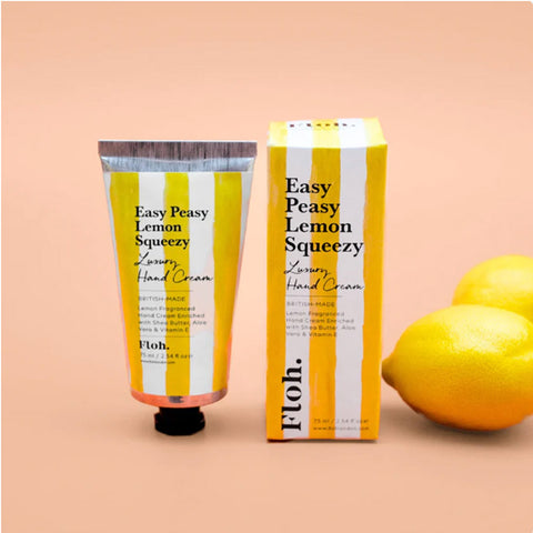 Hand cream with packaging and lemons on a peach background