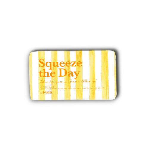Rectangular bar of lemon scented soap with yellow and white striped pattern wrapper with text 'Squeeze the Day' 