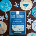 East End Press Garland packaging with decorative paper 'man in the moon' faces