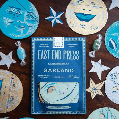 East End Press Garland packaging with decorative paper 'man in the moon' faces