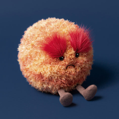 round, orange and red plush ty with fiery eyebrows and gold legs on a navy background