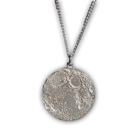 Silver necklace with textured pendant resembling the Moon.