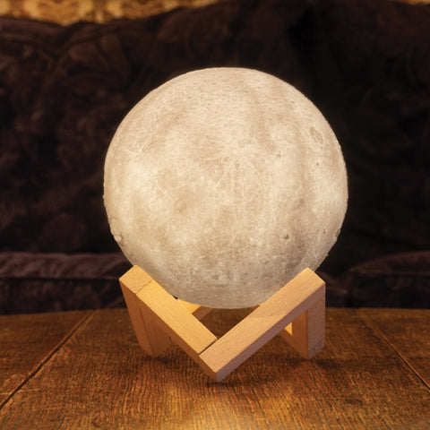 Moon lamp on a wooden stand with a dark background