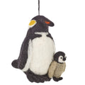 A felted wool penguin ornament with a larger black and white penguin and a smaller beige penguin cub, hanging by a black string 