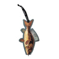 Fish-shaped brush with a black handle on a white background
