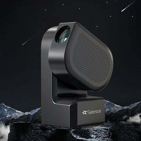 Black Seestar S50 astrophotography telescope on a mountainous landscape with a starry night sky