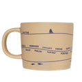 Beige mug with blue text and graphics on 