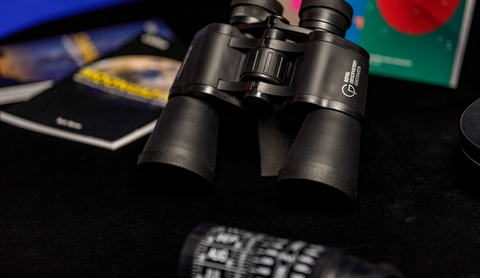 Royal Museums Greenwich Celestron binoculars in the Astronomy Photographer of the Year Gallery surrounded by other stargazing books 