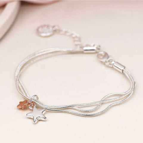 Silver snake-chain bracelet with silver and rose gold star charms.