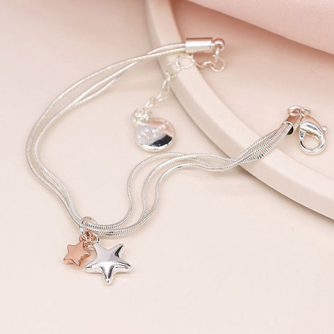 Silver snake-chain bracelet with silver and rose gold star charms.