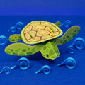 3D paper turtle model on a blue background