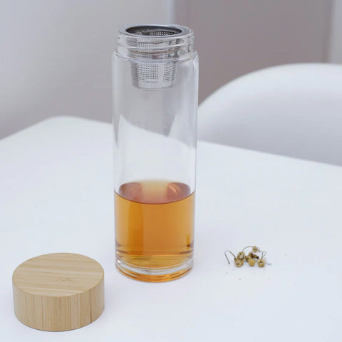 Tea in a glass bottle with metal infuser.