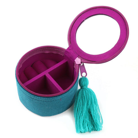 Teal jewelry box with pink interior and tassel on a white background