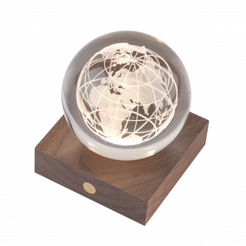 3D engraved globe design in a crystal ball on a wooden stand.